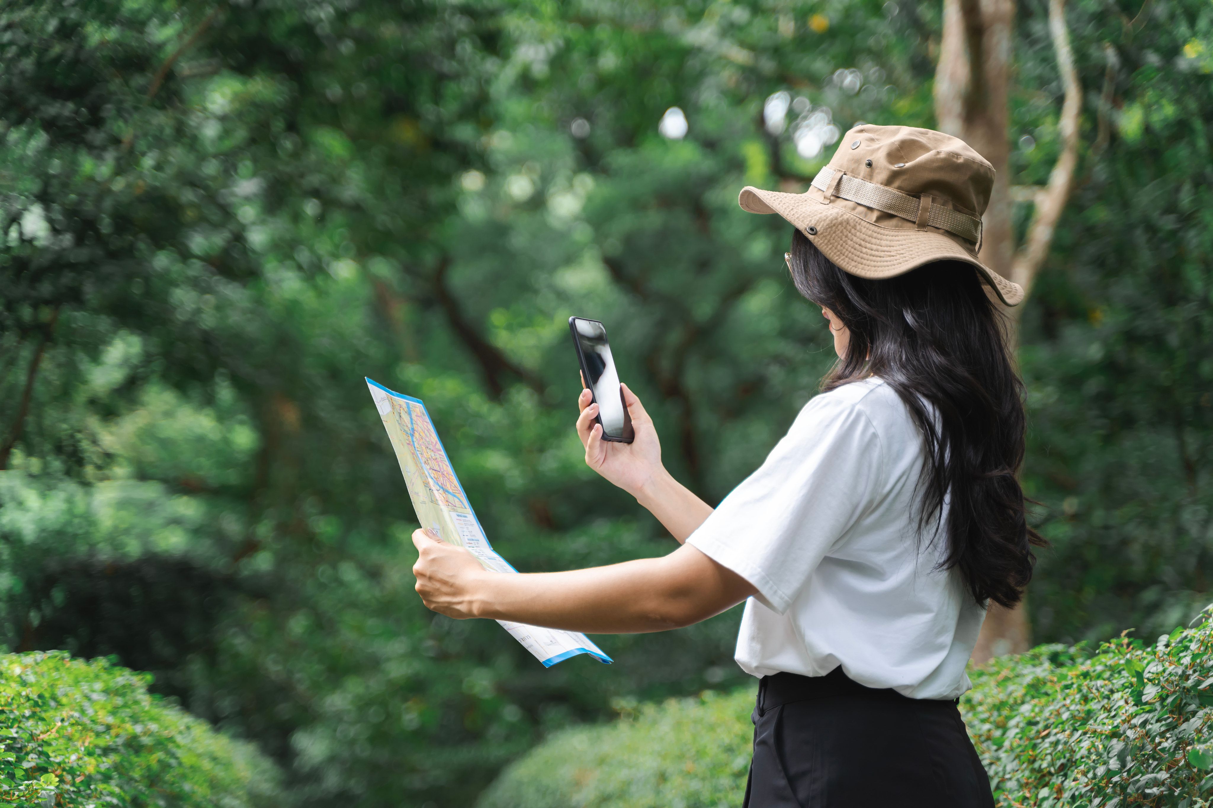 Woman with map exploring Zoo Negara